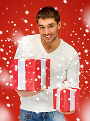 Image showing man holding many gift boxes