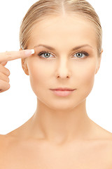 Image showing beautiful woman pointing to eye