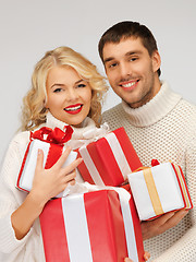 Image showing family couple in a sweaters with gift boxes