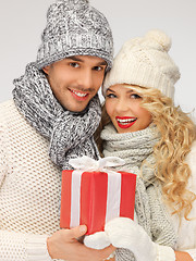 Image showing romantic couple in a sweaters with gift box