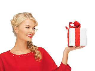 Image showing lovely woman in red dress with present