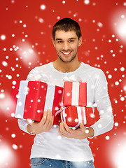 Image showing man holding many gift boxes