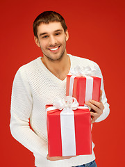 Image showing man holding many gift boxes