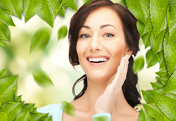 Image showing beautiful woman with green leaves