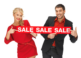 Image showing man and woman with sale sign