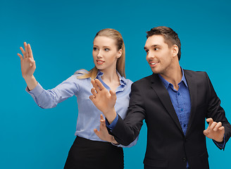 Image showing man and woman working with something imaginary