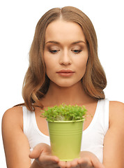 Image showing woman with green grass in pot