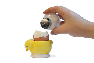 Image showing sprinkling salt on a boiled egg