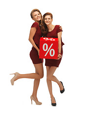 Image showing two teenage girls in red dresses with percent sign