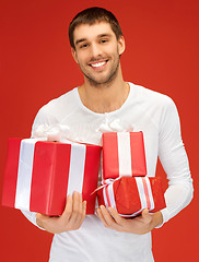 Image showing man holding many gift boxes