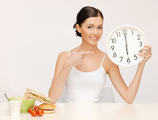 Image showing woman with big clock