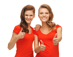 Image showing wo teenage girls in red t-shirts showing thumbs up