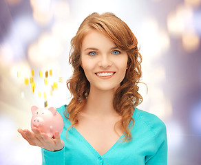 Image showing teenage girl with piggy bank