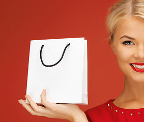 Image showing lovely woman in red dress with shopping bag