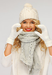 Image showing beautiful woman in a winter clothes showing heart