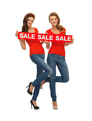 Image showing two teenage girls with sale sign