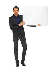 Image showing handsome man in suit with a blank board
