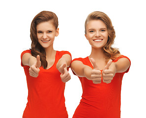 Image showing wo teenage girls in red t-shirts showing thumbs up