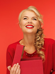 Image showing lovely woman in red dress with opened gift box