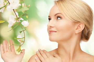 Image showing beautiful woman with flowers on twig