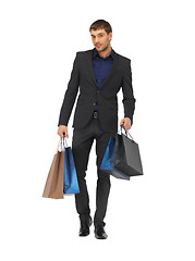 Image showing handsome man in suit with shopping bags