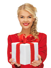 Image showing lovely woman in red dress with present