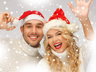 Image showing family couple in sweaters and santa's hats