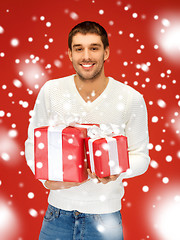 Image showing man holding many gift boxes