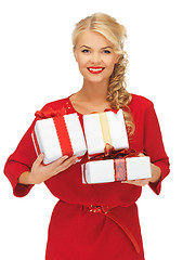 Image showing lovely woman in red dress with gift boxes