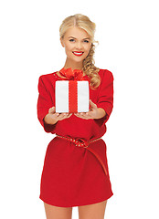 Image showing lovely woman in red dress with present