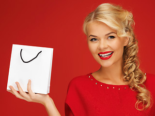 Image showing lovely woman in red dress with shopping bag