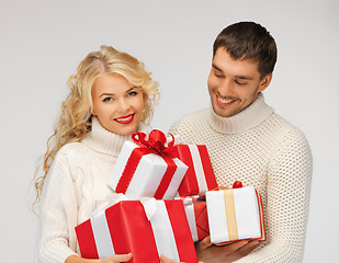 Image showing family couple in a sweaters with gift boxes