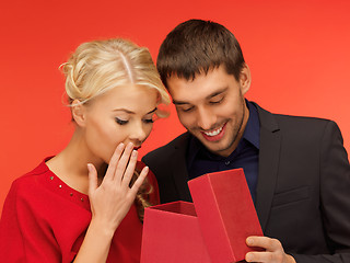Image showing man and woman looking inside the gift box