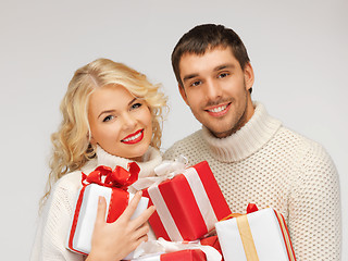 Image showing family couple in a sweaters with gift boxes