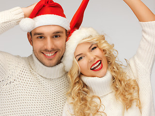 Image showing family couple in sweaters and santa's hats