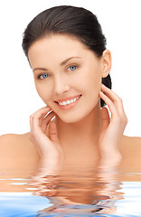 Image showing face and hands of beautiful woman in water