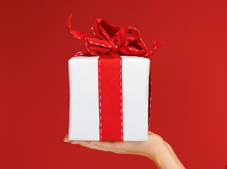 Image showing woman's hands holding a gift box