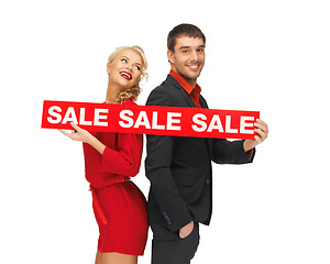 Image showing man and woman with sale sign