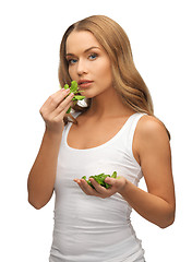 Image showing woman with spinach leaves on palms