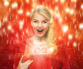 Image showing lovely woman in red dress with valentine gift box