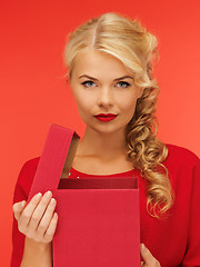 Image showing lovely woman in red dress with opened gift box