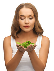 Image showing woman with spinach leaves on palms