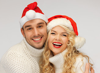 Image showing family couple in sweaters and santa's hats