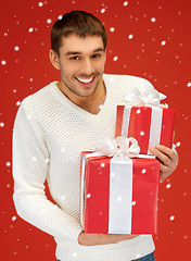 Image showing man holding many gift boxes