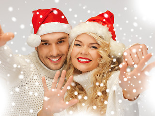 Image showing family couple in sweaters and santa's hats