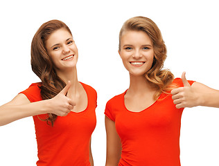 Image showing wo teenage girls in red t-shirts showing thumbs up