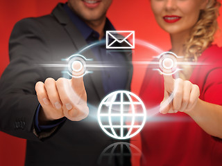 Image showing man and woman pressing virtual button