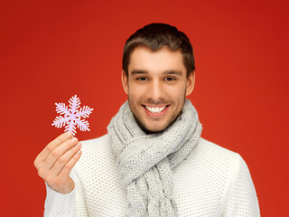 Image showing man in warm sweater and scarf with snowflake