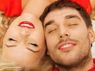 Image showing happy couple lying at home with closed eyes