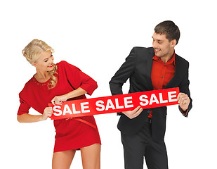 Image showing man and woman with sale sign